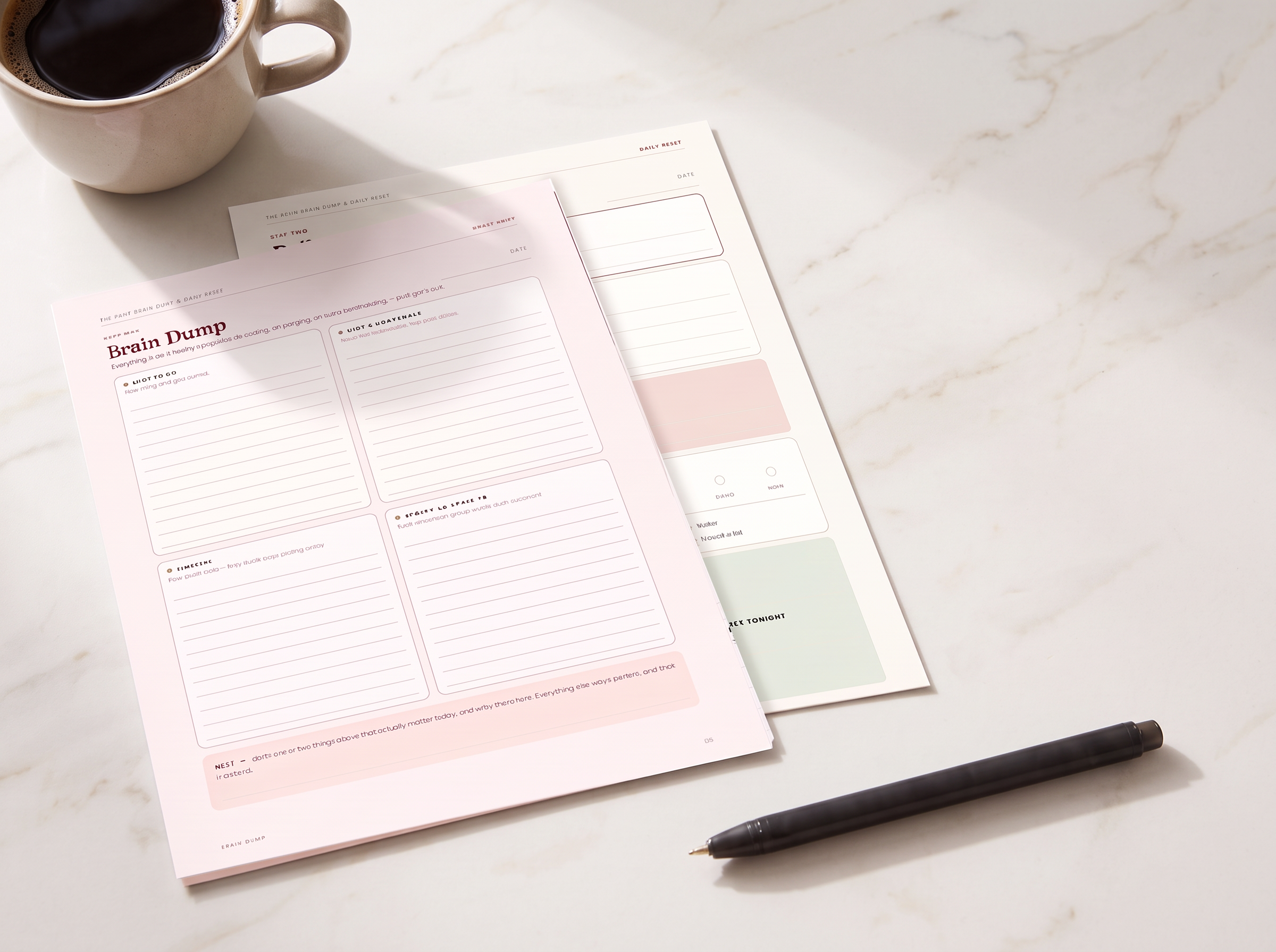 The Mom Reset Brain Dump and Daily Reset pages with coffee and a pen on a light marble kitchen table